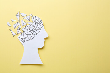 Human head with brain pieces made of paper on beige background, top view and space for text. Dementia concept