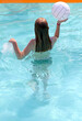 © TopMicrobialStock - Girl in a pool playing volleyball