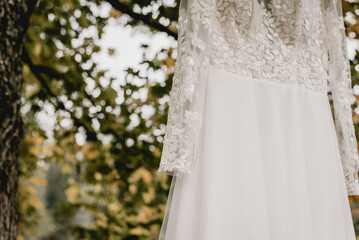 White wedding dress hanging close up shot