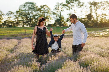 Happy family having fun with a child in a lavender field