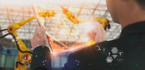 Wall Mural - industry engineer in factory,using smart tablet glass device,control automated robot arm machine lea