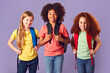 © Monkey Business - Studio Shot Of Three Children With Backpacks Going To School On Purple Background