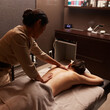 © Dragosh - Rear image of a young woman having a back massage treatment. Spa and healthy concept.