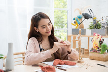 Young Asian Girl Making A Sculpture With Modeling Clay At Home .hobby Clay Sculpt Concept