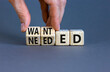 Wanted or needed symbol. Concept words Wanted or needed on wooden cubes. Businessman hand. Beautiful grey table grey background. Business Wanted or needed concept. Copy space.
