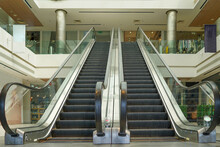Escalators In An Office Building Or Mall. Empty Escalator Stairs. Modern Escalator In Shopping Mall, Department Store Escalator. Empty Escalator Inside Building