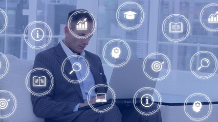 Poster - Animation of falling education icons over caucasian men using laptop