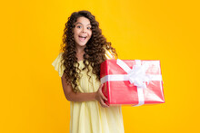 Emotional Teenager Child Hold Gift On Birthday. Funny Kid Girl Holding Gift Boxes Celebrating Happy New Year Or Christmas. Excited Teenager, Glad Amazed And Overjoyed Emotions.