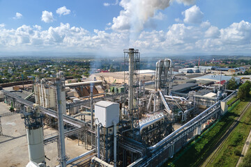 Aerial view of oil and gas refining petrochemical factory with high refinery plant manufacture structure. Global production and manufacturing concept