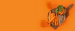 Leinwandbild Motiv Glasses of tasty carrot juice on orange background with space for text