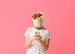 Young woman with tasty burrito instead of her head and mobile phone on pink background