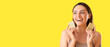 Leinwandbild Motiv Beautiful young woman holding soap bars on yellow background with space for text