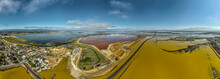 Aerial Panorama View Of Alviso District In San Jose California With Rundown Buildings Colorful Orange, Yellow Salt Marshes In The Bay Area