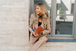 © Svetlana Sokolova - Stylish sucsessful blond woman sitting outdoor and holding advertising catalogs.