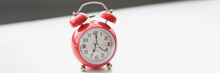 Retro Red Clock On White Surface Show Seven In Morning, Wakeup, Time For Work