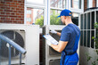 © Andrey Popov - An Electrician Men Checking Air Conditioning Unit