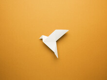 Origami Peace Dove On An Orange Paper Background, Freedom Or Peace Concept