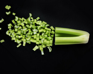 Wall Mural - Raw celery on dark background.