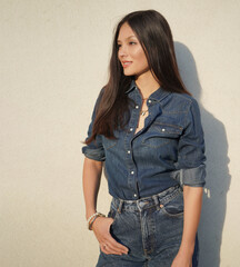 a girl in denim clothes with long hair 