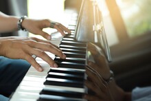 A Rocker Man Plays The Piano In The Music Room At School. Favorite Classical Music Show Your Fingers On The Piano Keyboard.