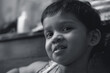 © suprabhat - Monochromatic portrait of a little Bengali (Indian ethnicity) girl with expressive face, looking at camera. Photo taken inside her room.