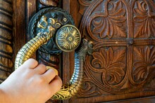 Iron Handle In The Form Of A Dragon With A Lion's Head On An Old Wooden Door