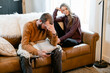 © Leah Flores/Stocksy - An Unhappy Couple Sit Together on a Couch