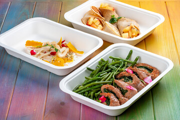 A set of healthy food dishes in ecological packaging on a wooden background. Food delivery. Takeaway.