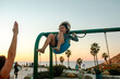 © Erin Brant/Stocksy - Mother watching happy girl on swing