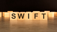 Word SWIFT Written On Wooden Cube Block Stack On Black Background, Business Concept