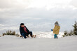 © Ani Dimi/Stocksy - Grandpa And Grandson having fun on the snow
