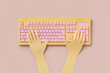 © Yaroslav Danylchenko/Stocksy - Papercraft human hands typing on colorful computer keyboard