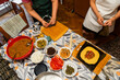 © Felix Chacon/Stocksy - Hands making Venezuelan food at home