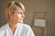 © Ivan Ozerov/Stocksy - Middle aged woman looking away during spa session