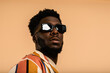 © Valentina Barreto/Stocksy - Black man with sunglasses summer portrait