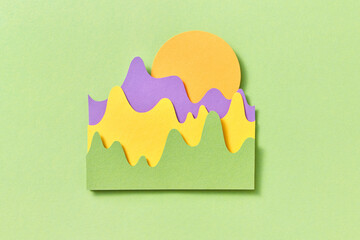 Papercut sunrise over mountains