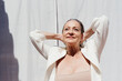 © Eloisa Ramos/Stocksy - Delighted mature woman enjoying sun reflections portrait