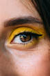 © VICTOR TORRES/Stocksy - Close-up of a girl's eye with yellow shadow