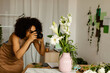 © Valentina Barreto/Stocksy - Florist photographing floral vase at work