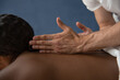 © Milles Studio/Stocksy - Crop masseur rubbing back of customer