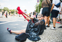 Dramatic Man Putting Long Red High Heel Boots On Pride