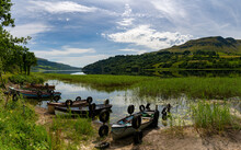 Glencar Lough Landscape With Many Colorful Small Wooden Fishing Boats On The Lakeside