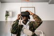 © Ezequiel Giménez/Stocksy - Happy black man in VR glasses exploring cyberspace