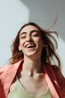 © Sergey Filimonov/Stocksy - Carefree woman smiling happily - Freedom - Flying hair