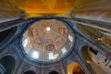 Close up of the interior of the octagonal dome and ceiling of the historic Baroque Church of St. Catherine in Livorno, Italy.