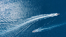 Two Speedboats Passing Each Other In The Blue Sea