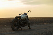 Retro Motorcycle Near Field At Sunset