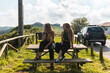 © Manu Prats/Stocksy - Women friends watching swell from the beach