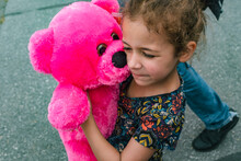 Little Girl Holding Pink Stuffed Teddy Bear