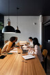 © Bisual Studio/Stocksy - Diverse employees working in office